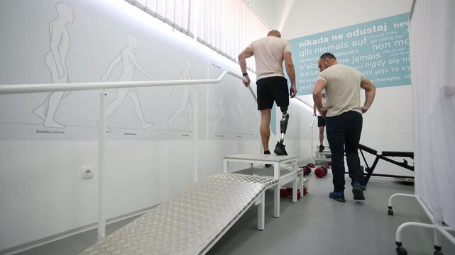 An amputee test his prosthesis in exercise room