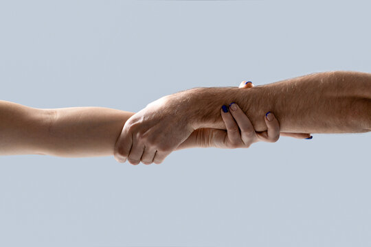 Giving a helping hand to another. Woman and man hand. Hands man and woman reaching to each other, support. Hands of male and female holding together. Woman and man holding hands together