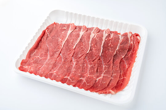 A box of beef chuck slices on a white background