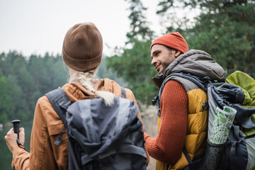 Fototapeta premium Couple enjoying a joyful hike through colorful autumn forest trails