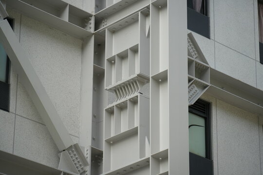 A steel seismic brace installed on a modern building exterior.