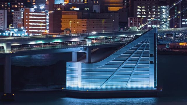 Suspension Bridge Architecture Night Scene with Illuminated Base and Flowing Traffic 4k Timelapse Shot Capturing Urban Bridge Structure over River Water in Metropolitan City