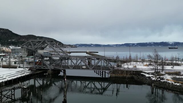 Railway bascule bridge mirrored in the canal at Skansen Trondheim in winter