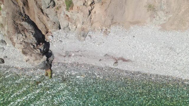 Coastline of Nerja, Spain, aerial birdseye view tilting up and moving backwards