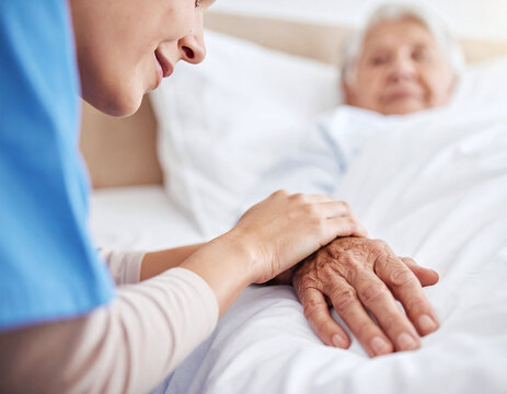 A compassionate nurse gently holds an elderly patients hand in a bright clinic bed, offering warm comfort, empathy, and professional healthcare support to senior citizens.