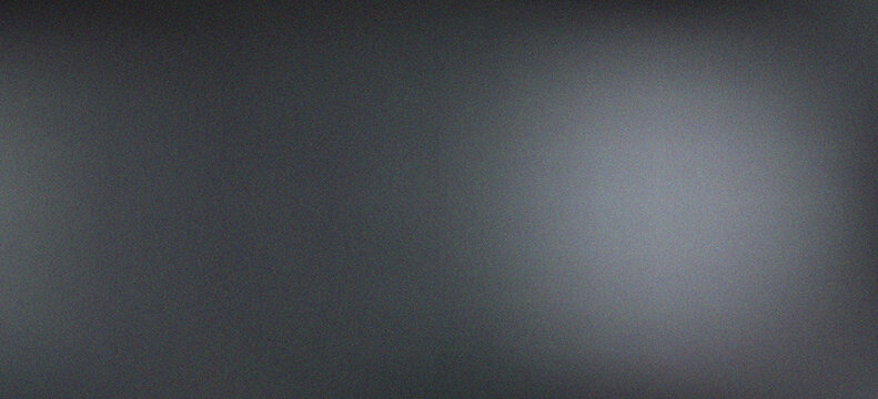 Dark black and silver metallic gradient abstract background with soft glow and fine grain texture