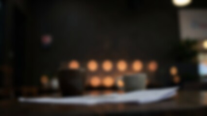 Obraz premium blurred dark workspace table with warm bokeh for financial