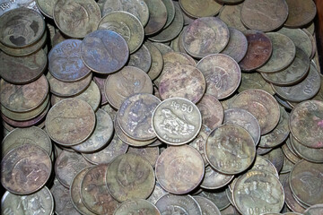 Large collection of antique or vintage metal coins, both domestic and foreign that once circulated and now show signs of weathering and oxidation.  © Joshua Prasetyadi