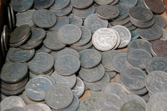 Stack of 25 Rupiah aluminum or nickel coins issued by Bank Indonesia, predominantly featuring the 1971 issue which displays the national emblem Garuda Pancasila and the face value. 