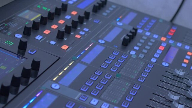 Camera slider shot across audio mixing console