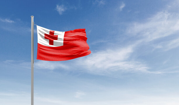 Tonga national flag waving in the sky.