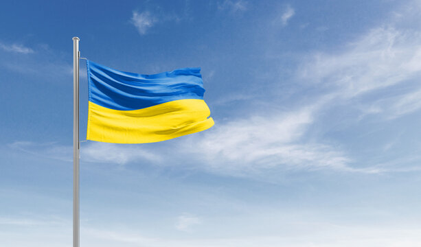 Ukraine national flag waving in the sky.