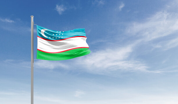 Uzbekistan national flag waving in the sky.