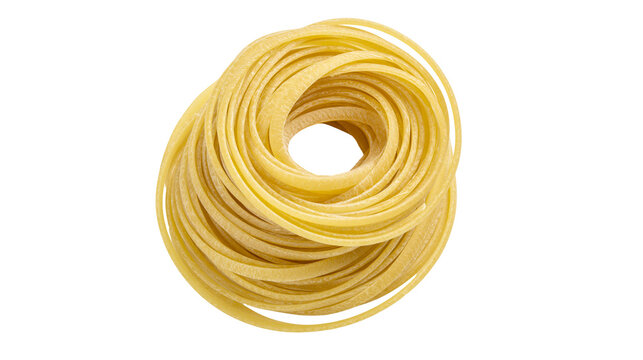 Raw spaghetti nest uncooked pasta strands, yellow dried noodles