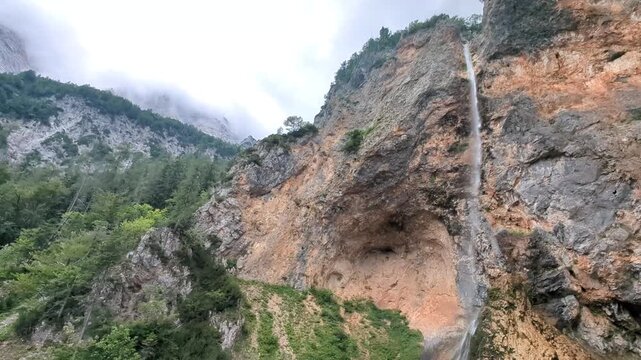 Scenic Rinka waterfall in Logar valley Slovenia surrounded by lush green forest