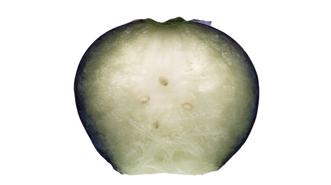 Green apple cut in half showing seeds and flesh