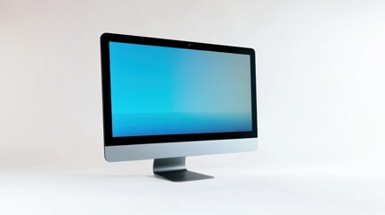 Fototapeta premium A silver computer monitor with a blue screen on a white background