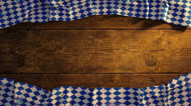 Rustic wooden table with blue checkered fabric border and copy space for oktoberfest design.