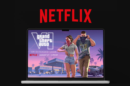 MacBook Laptop Screen Displaying Grand Theft Auto VI GTA6 Extended Look Trailer Announcement with Netflix Logo on Black Background
