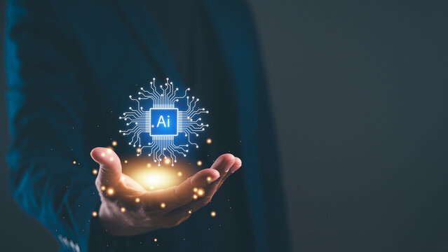 A person in a suit holds a glowing AI chip icon with circuit connections, symbolizing artificial intelligence and technology innovation.