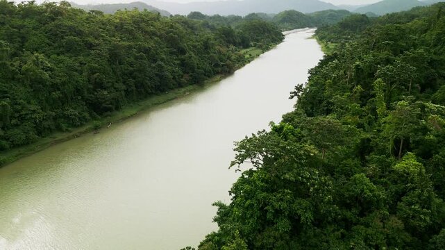 Picturesque aerial overview of the wide Pajo River flowing through dense tropical island greenery - Catanduanes, Bicol, Philippines