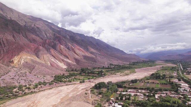 4K drone aerial view of Paleta del Pintor in Maimar&aacute;, Jujuy, Argentina. Iconic colorful mountain landscape in the Quebrada de Humahuaca, with vibrant geological layers shaped by erosion.