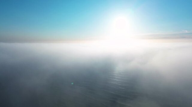 Bright sunlight shines above clouds over the Baltic Sea.