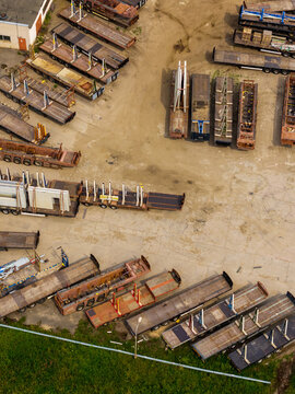 Aerial view of a logistics yard filled with rows of flatbed trailers and industrial transport equipment in Vilnius, Vilnius County, Lithuania.