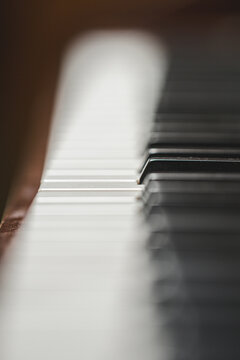 Blurred piano keyboard creating atmospheric abstract music background.