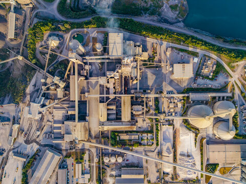 Aerial view of the CCB Granulats Gaurain industrial plant featuring large silos, conveyor belts, and processing facilities surrounded by greenery in Tournai, Wallonia, Belgium.
