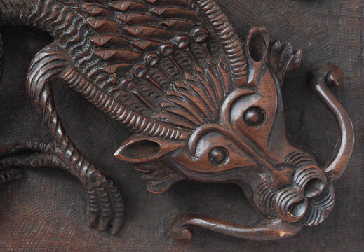 Detail of an antique Kashmiri box with a dragon carving on the lid