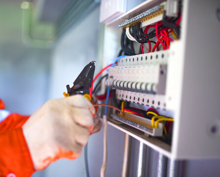 Professional Electrician Installing and Troubleshooting Electrical Control Panel Wiring for Commercial Electrical Systems