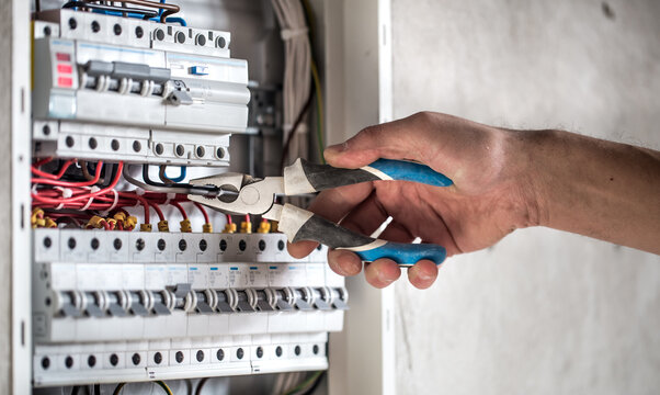 Certified Electrician Servicing Electrical Distribution Panel for Safe and Reliable Power System