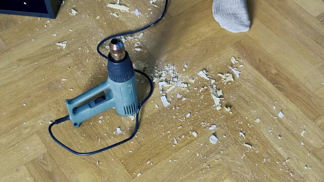 Heat Gun on Parquet Floor with Stripped Paint Chips