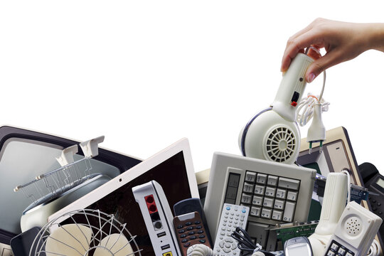 E-waste Recycling with Hand Placing Vintage Hairdryer on Pile of Electronics Outdoors