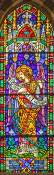 PISA, ITALY - JUNE 25, 2026: The St. Archangel Raphael from the stained glass in the church Chiesa di Santa Caterina by K&ouml;nigliche Bayerische Hofglasmalerei F. X. Zettler (1922 - 1924)