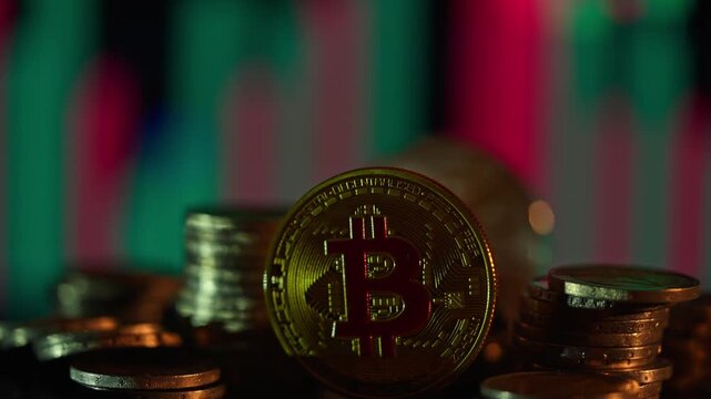 Gold physical coin rests prominently among stacked metal tokens against an abstract illuminated background of vertical red and green glowing lines, symbolizing decentralized wealth and online trading.