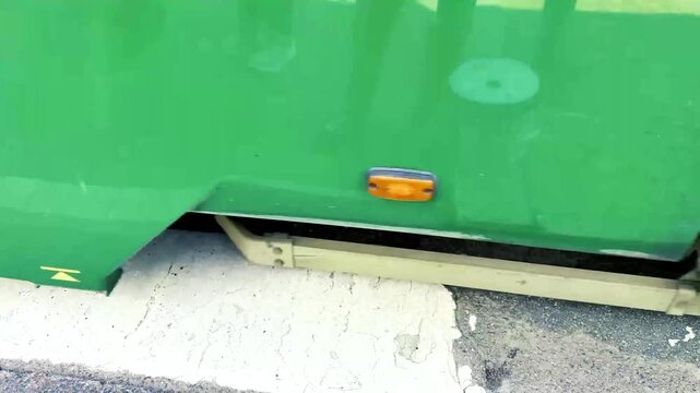 Green Tram Passing Over Street of Helsinki Rails Seen Close-up