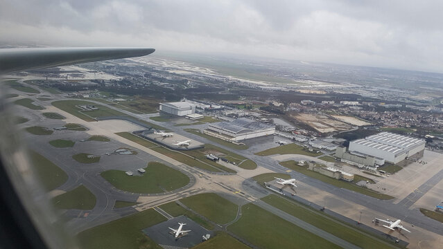 Paris, France - March 28, 2018 - Takeoff from Charles de Gaulle Airport Paris in rain with control tower from airplane window