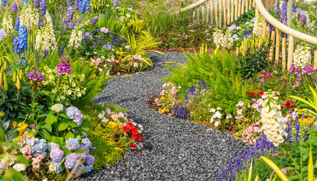 colorful flowers with rock path leading through a flower garden