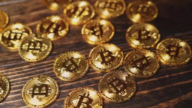 Gold coins marked with digital currency symbols spread across a dark textured wooden table to represent the chaotic yet potentially lucrative nature of investing in highly volatile modern market.