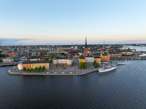 Aerial view of the historic Gamla Stan district in Stockholm, featuring colorful buildings, the Riddarholmen Church spire, and the waterfront in Stockholm, Stockholm County, Sweden.