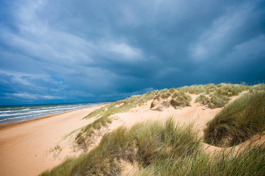 Dark cloudy sky over long sandy beach near Mellbystrand in Laholm Municipality, Sweden