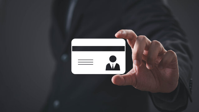 Business professional holding a digital identification card, representing digital identity, employee credentials, identity verification, secure access, authentication, business security, and access.