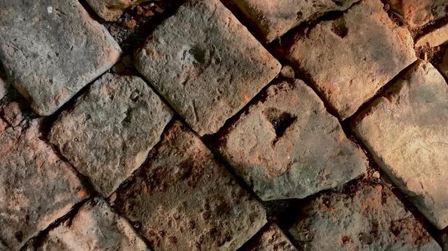 Aged cobblestone pavement with rustic geometric patterns, detailed stone texture background perfect for architecture, historic streets, construction, urban design, and outdoor projects.
