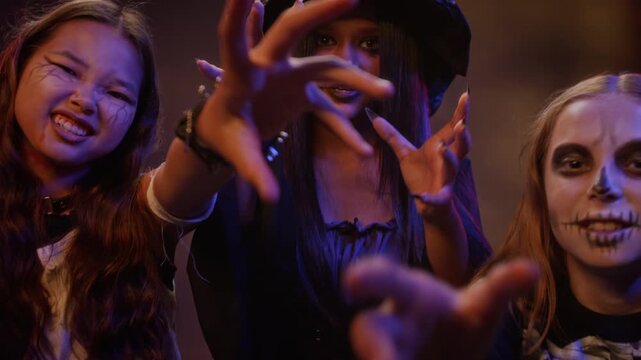 Portrait of diverse teenagers wearing Halloween makeup gesturing spookily towards camera. Clip is ideal for seasonal holiday marketing