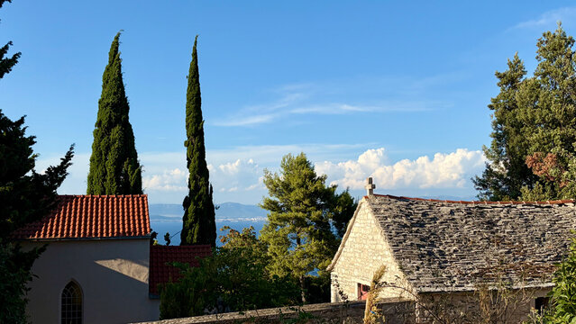 Traditional Stone Houses and Cypress Trees on Croatian Island at Golden Hour