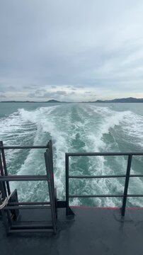 Boat wake prop wash on blue ocean sea