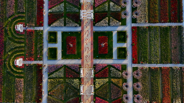 Aerial view of the geometric flower beds and vibrant rose gardens at Karatay Mevlana Gul Parki with symmetrical walking paths and pergolas in Karatay, Konya, Turkiye.