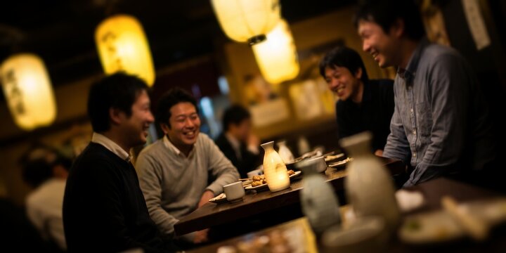 Group of Japanese businessmen at an izakaya pub showcasing traditional paper lanterns, sake bottles and warm smiles, representing social bonding and after work relaxation
